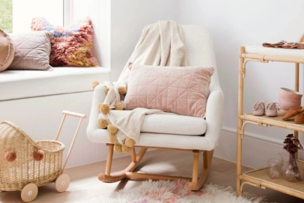 Nursery with rocking chair, basket, and rug. Learn how to clean and maintain your breastfeeding armchair.