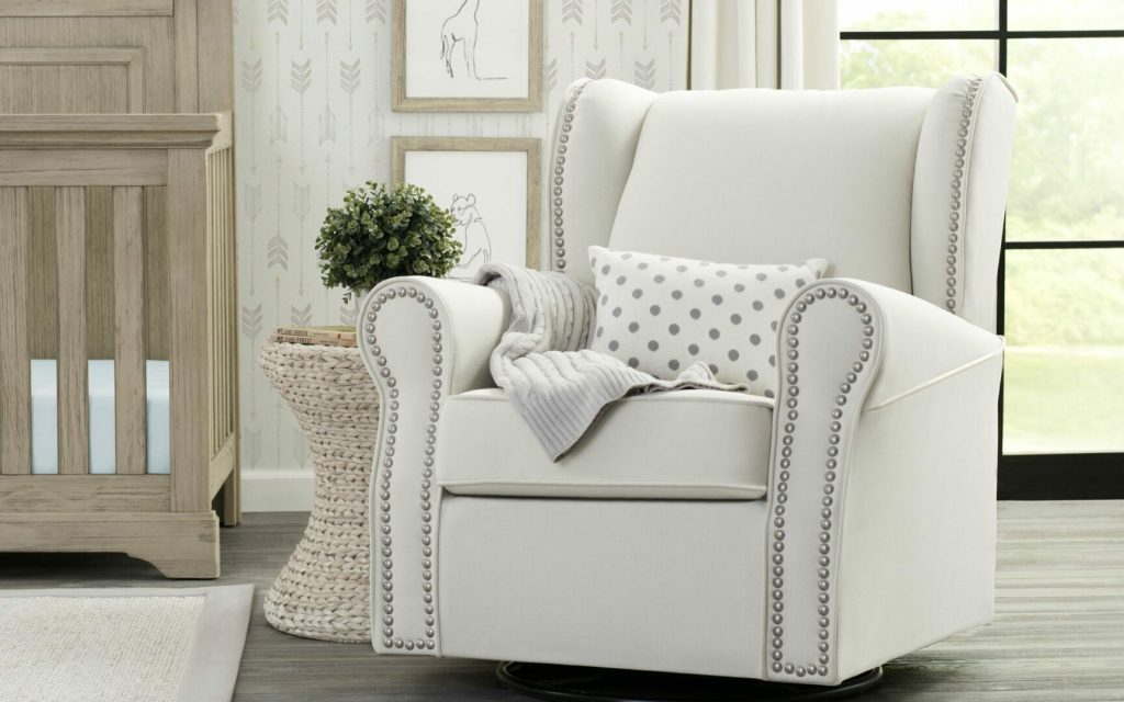 White baby chair with blanket and pillows, essential for nursing.