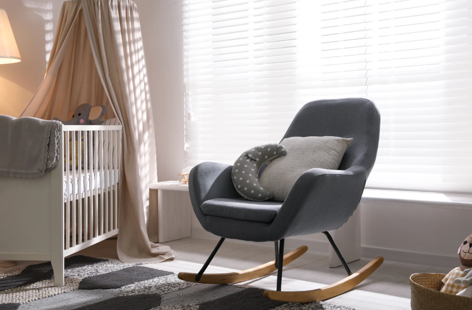 A rocking chair in a baby's room, designed for breastfeeding and creating special moments with your little one.