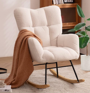 Comfortable rocking chair with blanket, great for breastfeeding.