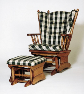 A wooden rocking chair with plaid cushions, accompanied by a matching footstool, both set against a plain white background—showcasing what makes a good nursing chair.